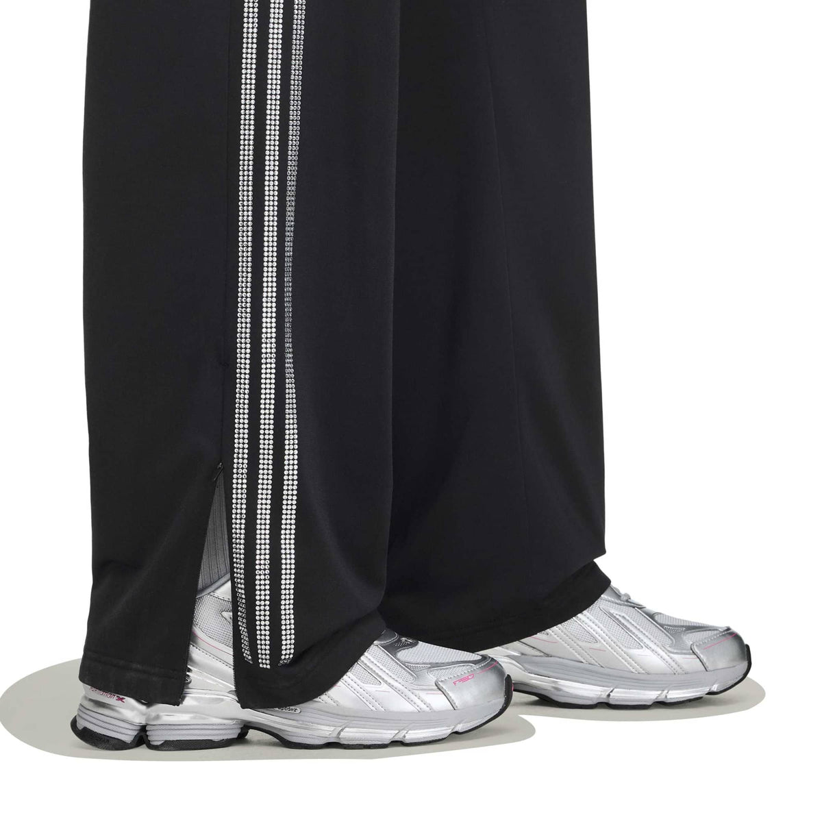 black and silver rhinestone track pants on a white background