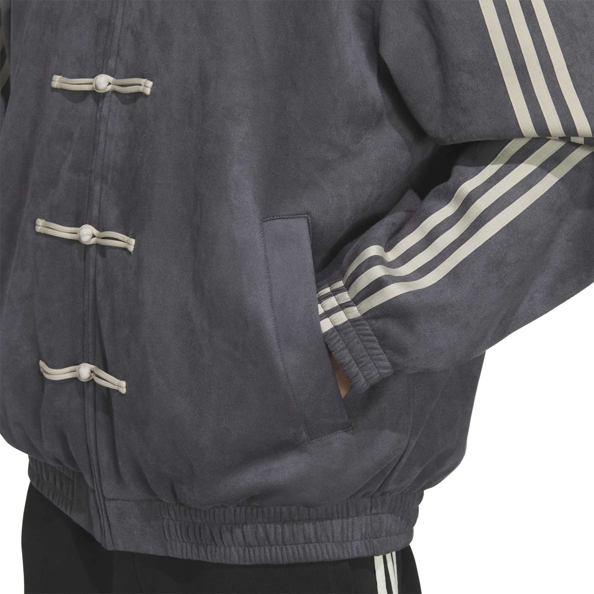 person wearing a grey jacket on a white background